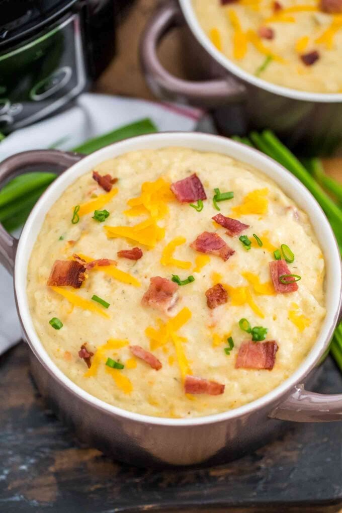 A bowl of homemade creamy and cheesy potato soup garnished with bacon and cheddar cheese