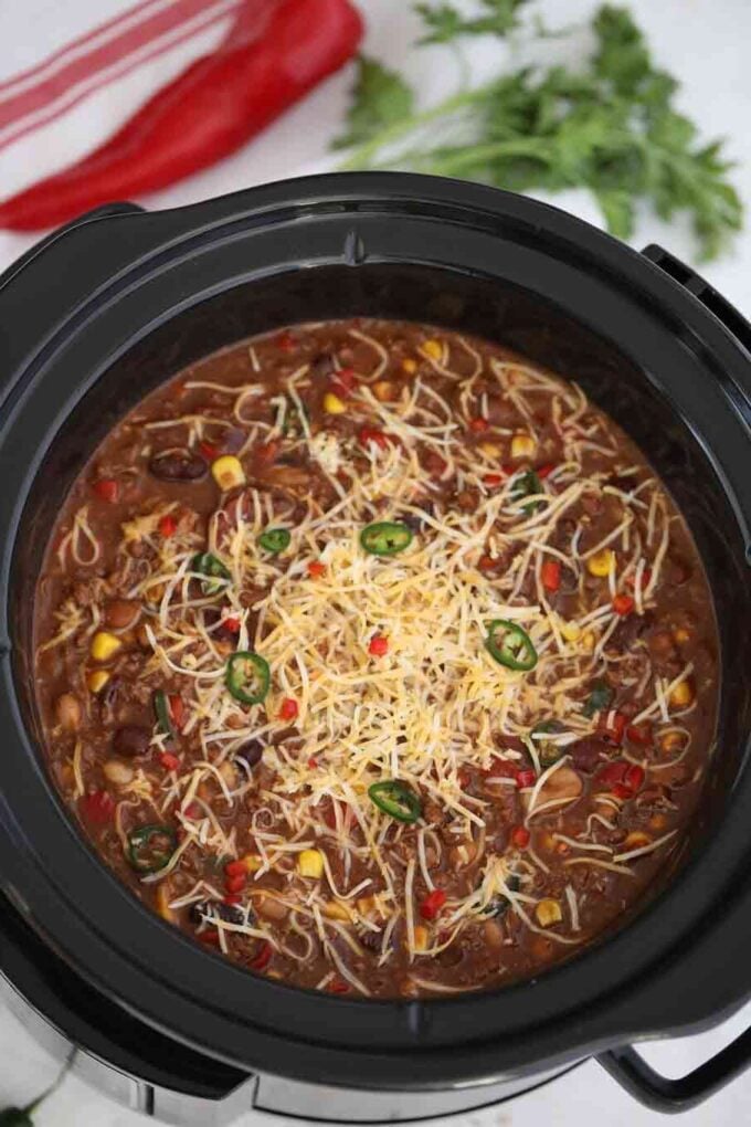 Homemade slow cooker beef chili topped with shredded cheese