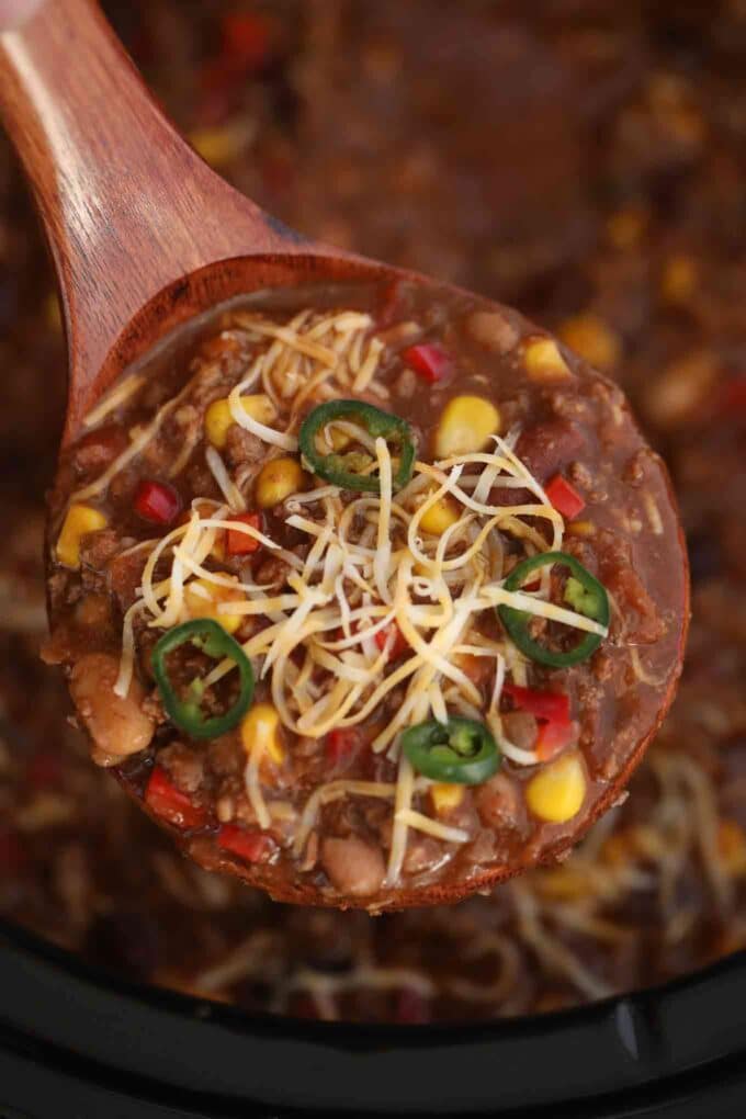 Crockpot beef chili on a wooden spoon