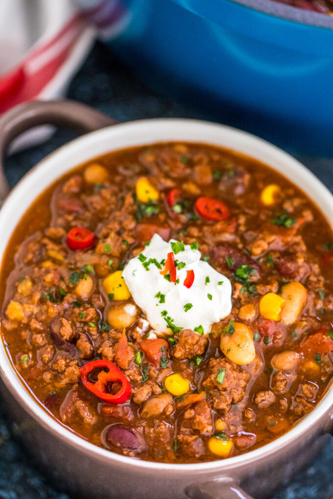 A bowl of homemade beef chili topped with sour cream. 