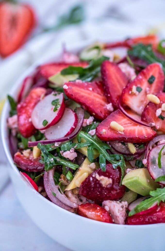 Arugula Strawberry Salad in a white bowl. 