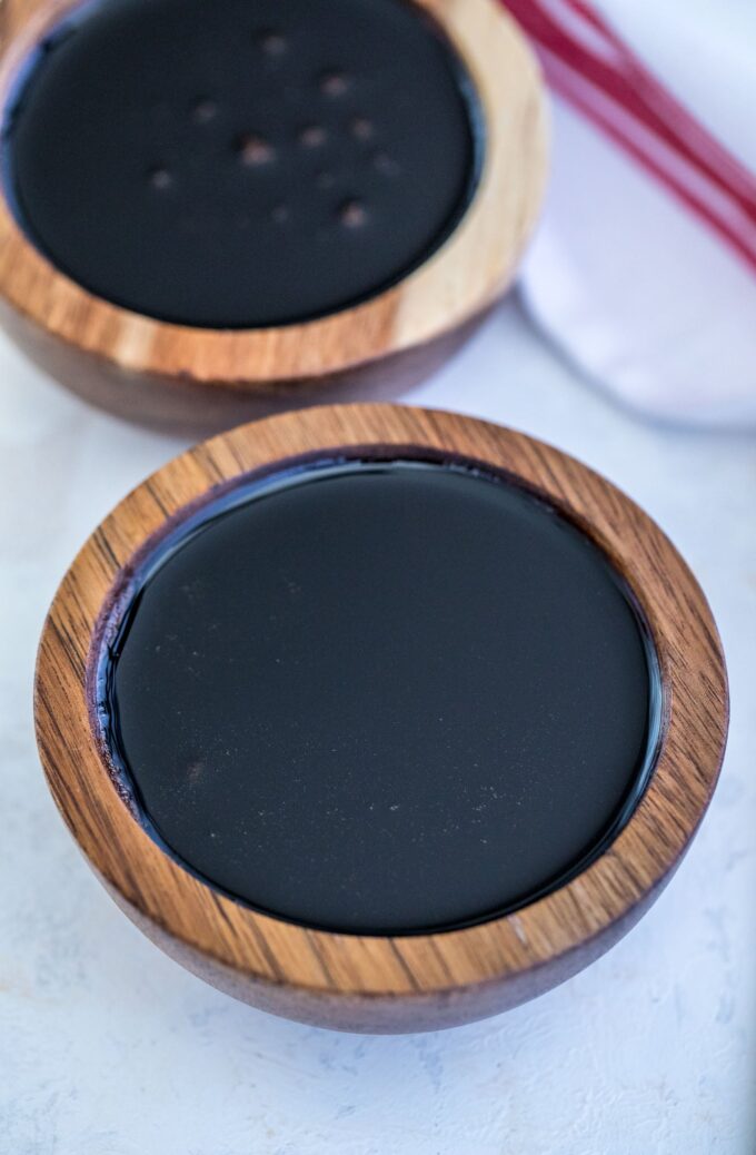 Balsamic glaze in two wooden dipping bowls