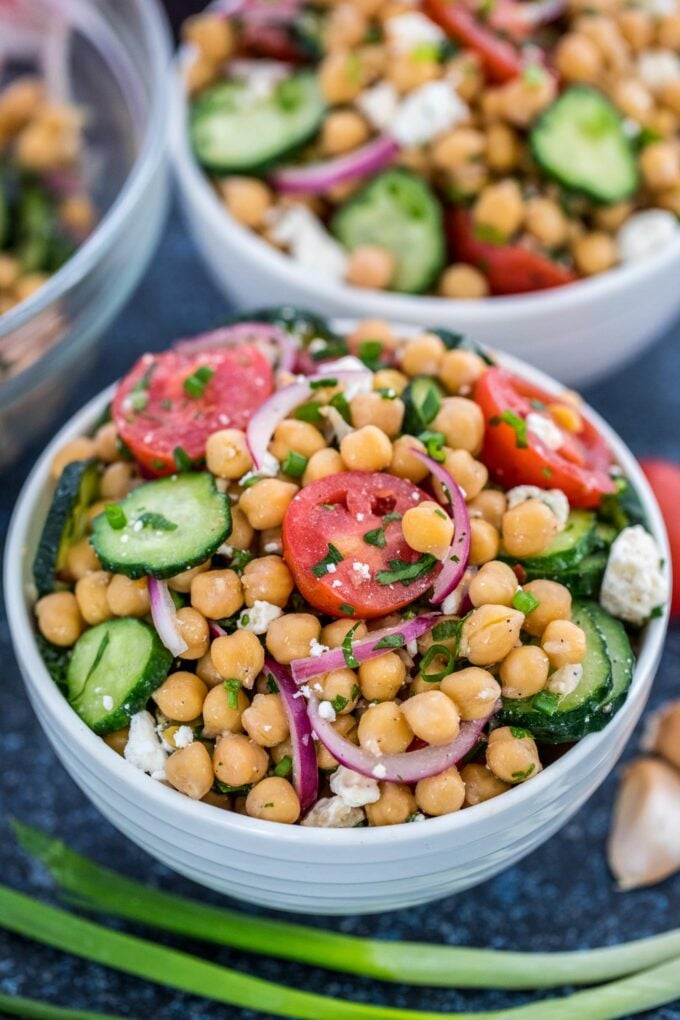 Freshly made chickpea Salad in a large white bowl.