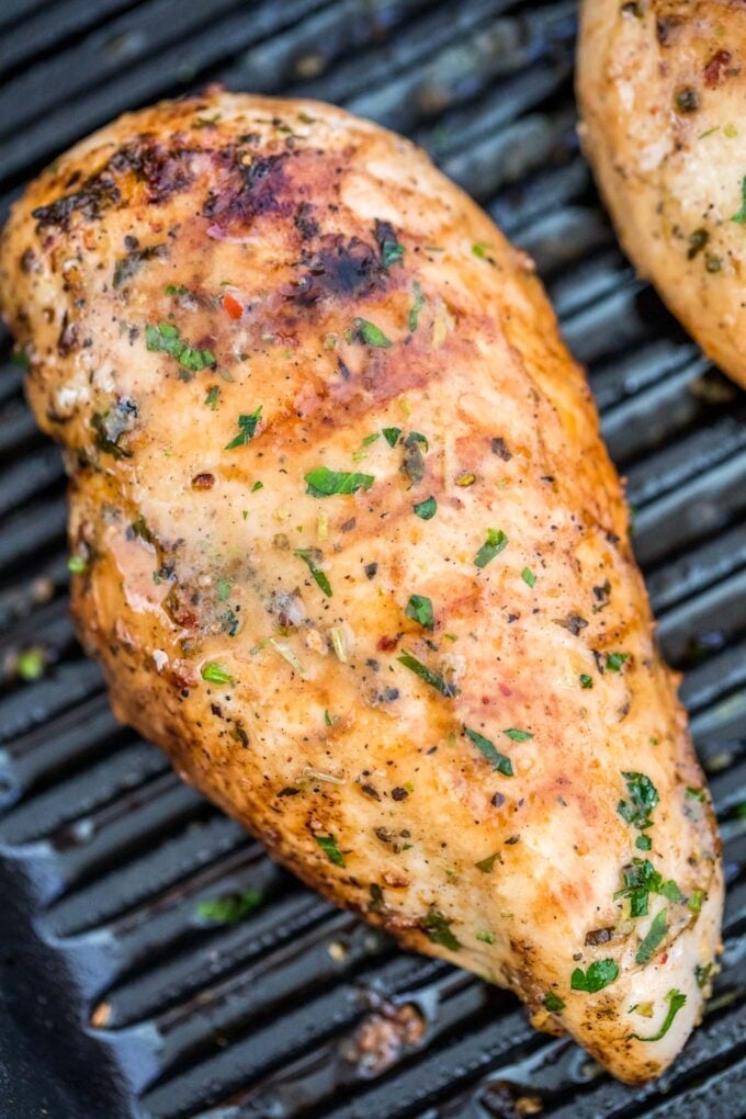 Grilled chicken breasts with grill marks in a grill pan