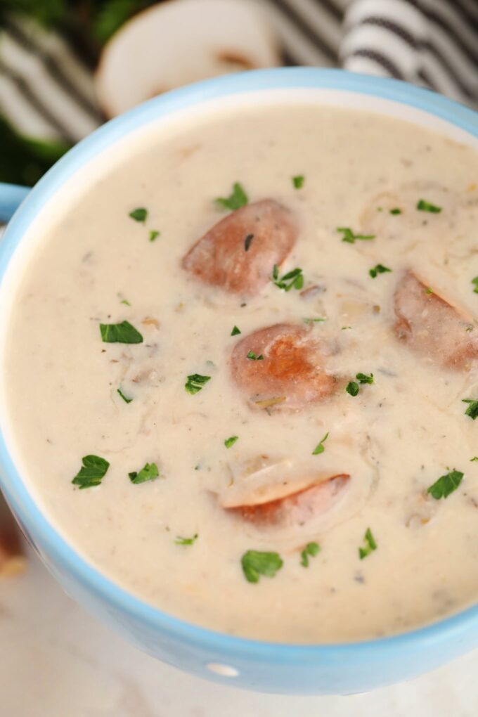 Pressure cooker instant pot cream of mushroom soup garnished with chopped parsley photo.