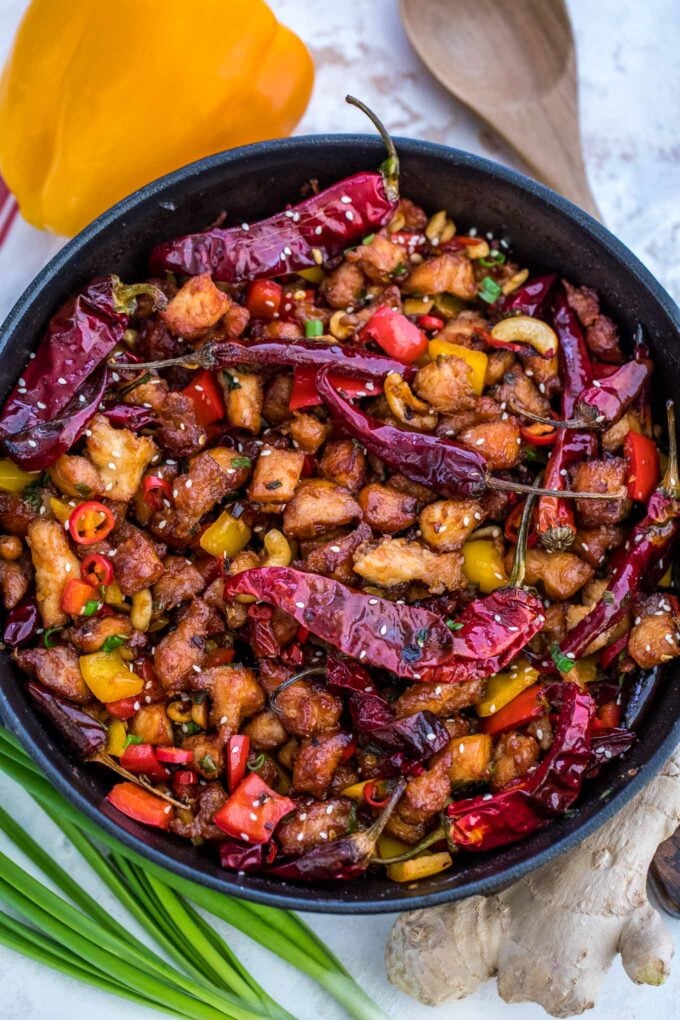 Szechuan chicken with vegetables and chili peppers in a skillet