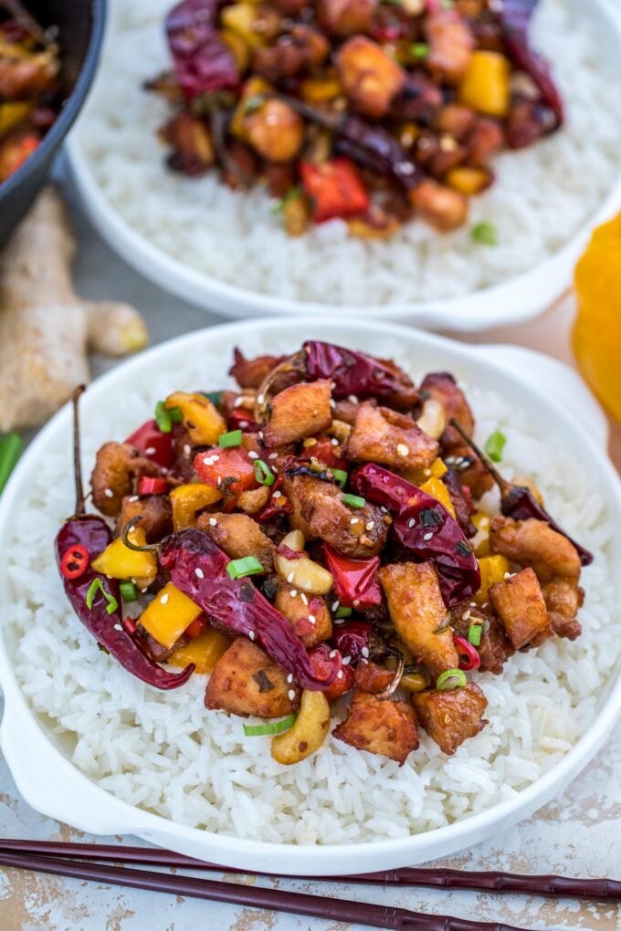 Szechuan chicken served over white rice in bowls