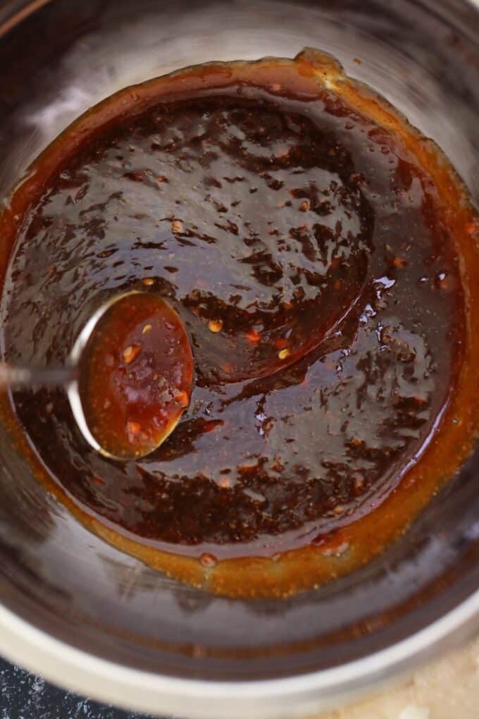 stirring homemade Szechuan sauce with a spoon