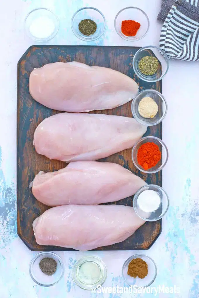 chicken breasts and seasonings on a table