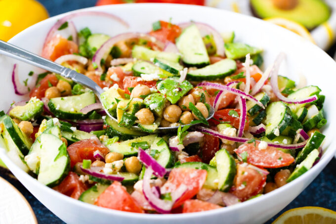 A bowl of fresh chickpea salad with feta cheese.