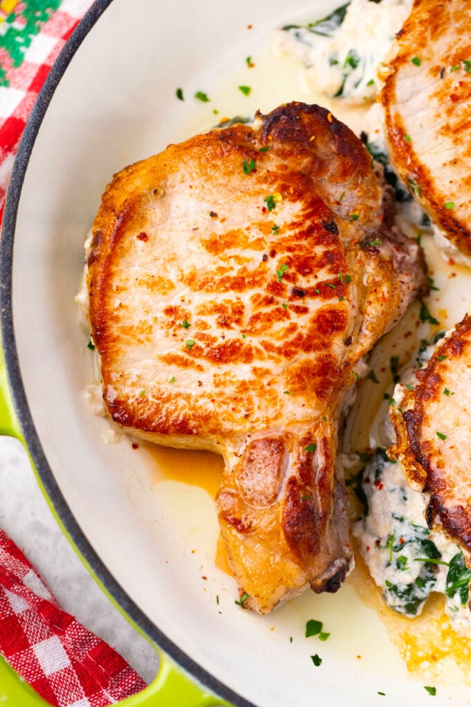 Golden cheesy spinach dip stuffed pork chops.