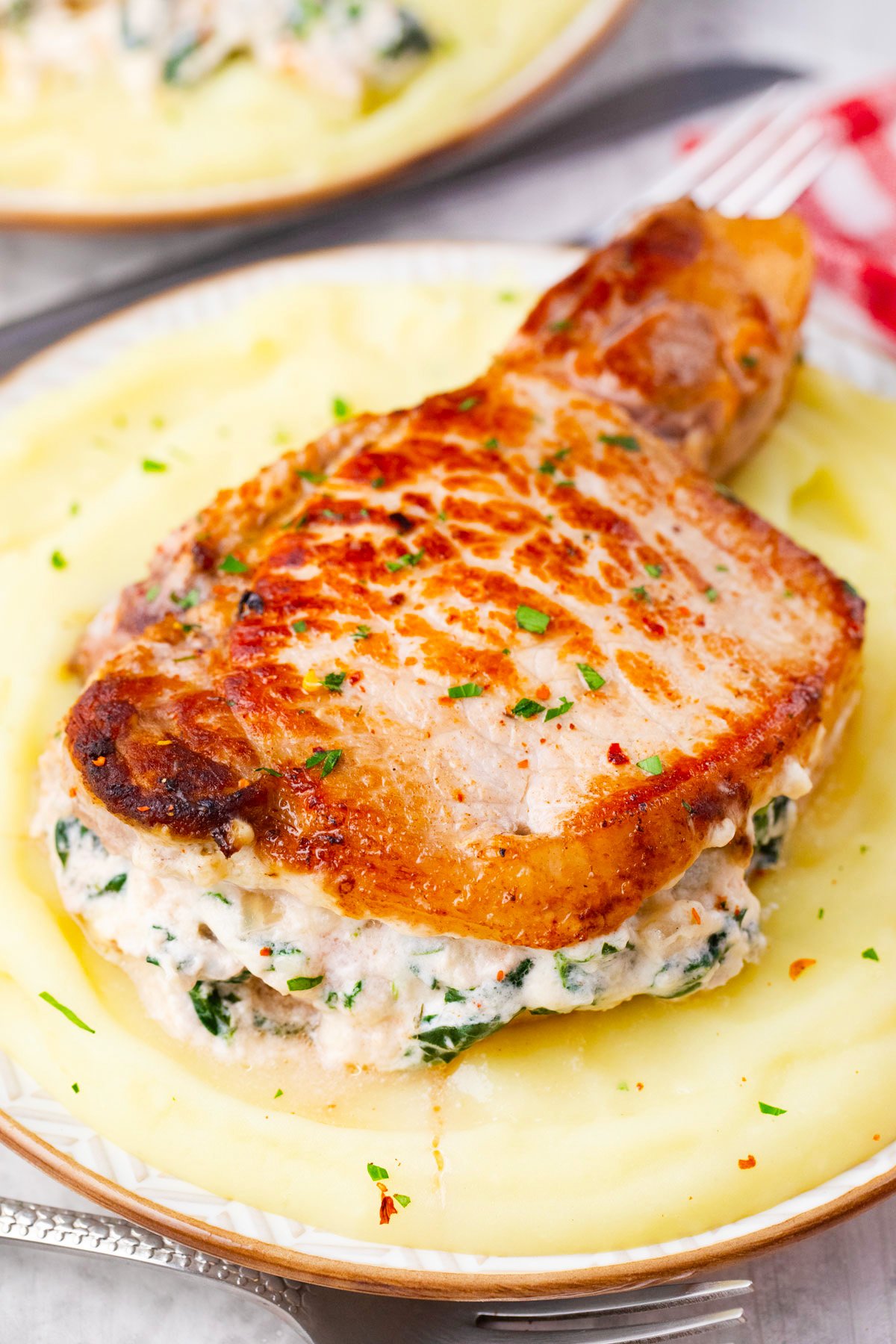 Perfectly seared cheesy spinach dip stuffed pork chops.