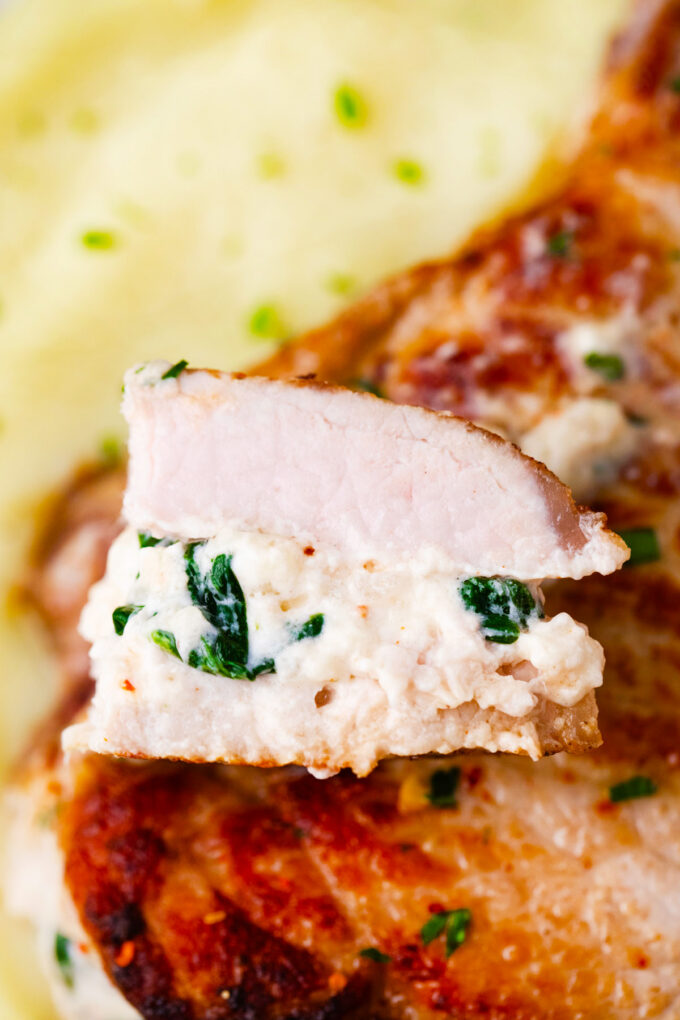 Cheesy spinach dip stuffed pork chops.