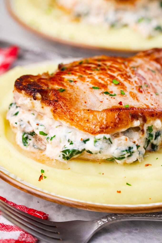 Close shot of cheesy spinach dip stuffed pork chops.