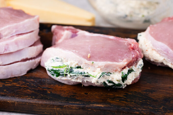 Stuffing pork chops with spinach dip filling.