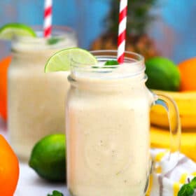 Photo of tropical smoothie with mango bananas pineapple and lime.