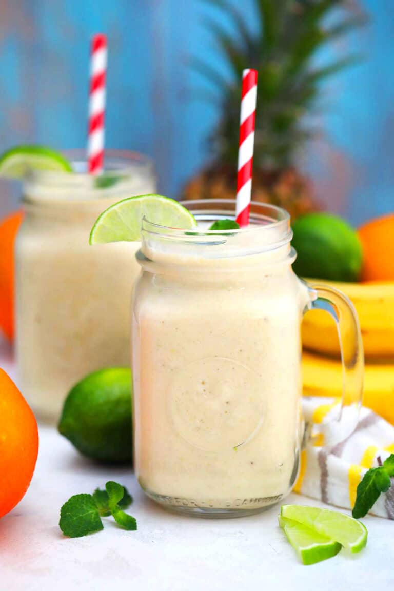 Photo of tropical smoothie with mango bananas pineapple and lime.