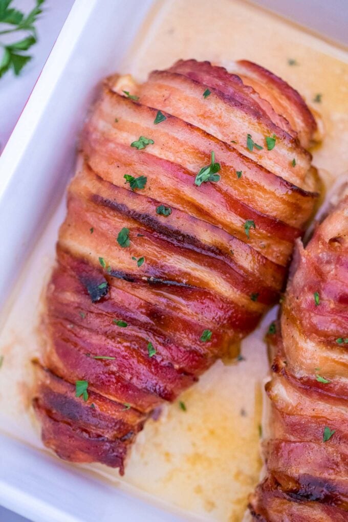 Image of bacon wrapped cream cheese stuffed chicken.