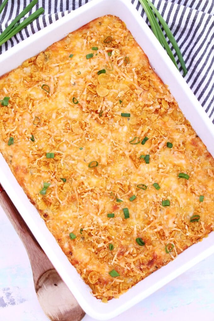 Image of cheesy potatoes in a casserole dish. 