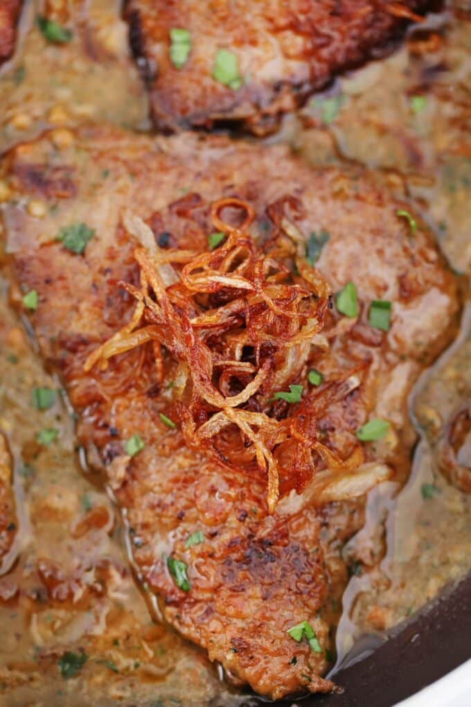 Cube steak topped with caramelized onion and gravy.