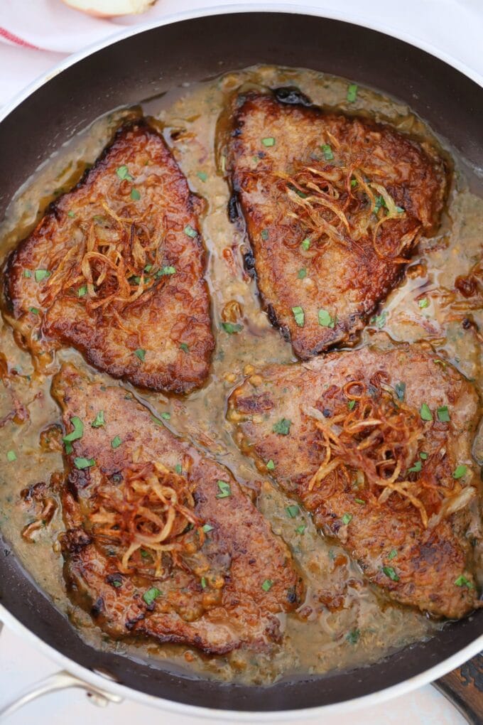 Beef cube steak in the skillet with gravy