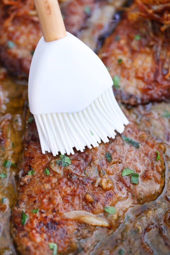 Tender cube steak with gravy in a pan