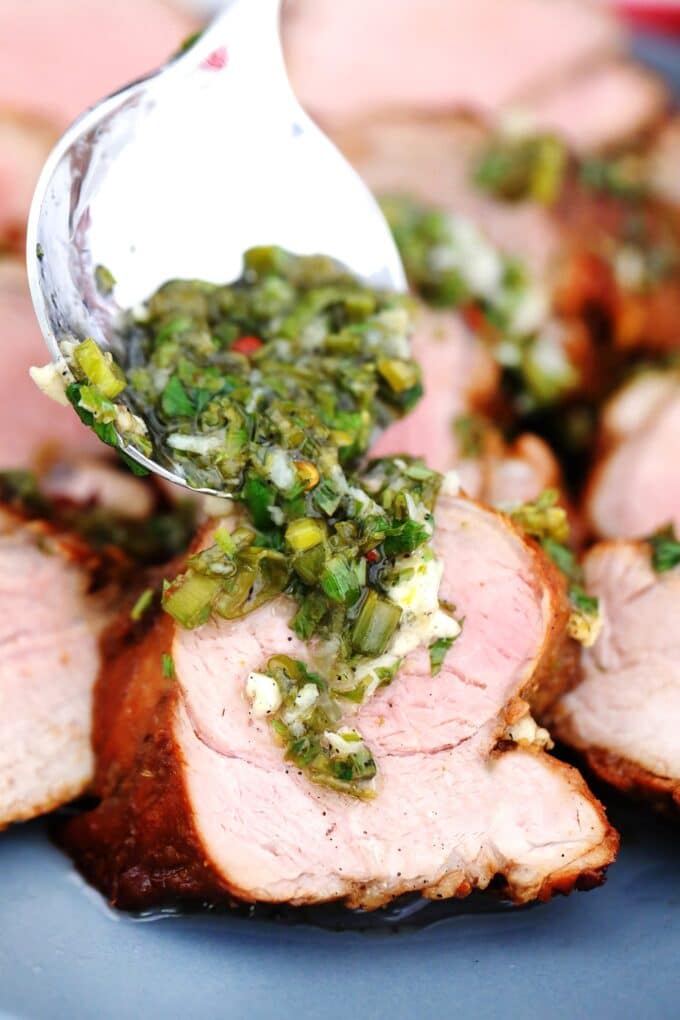Image of grilled pork tenderloin garnished with chopped green onions.