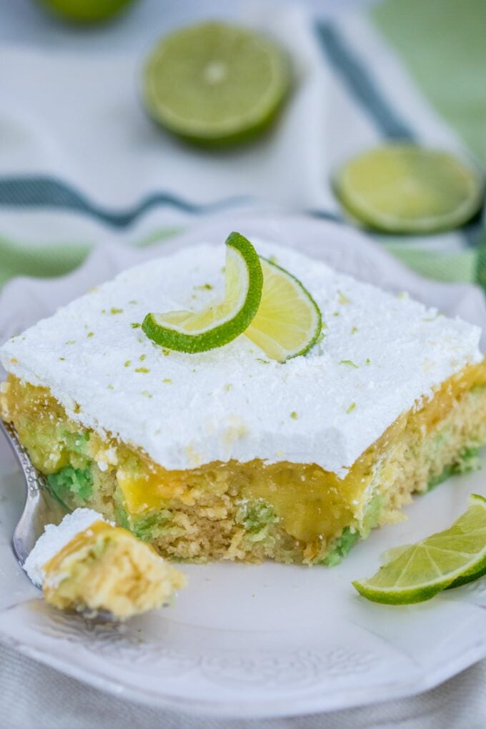 Photo of a slice of key lime pie poke cake.