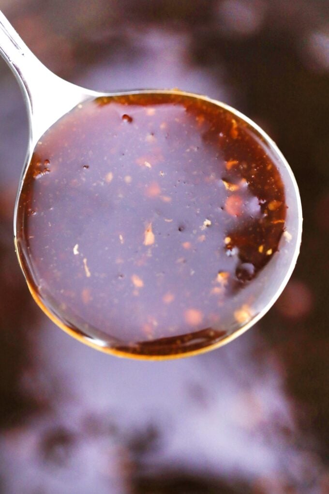 Image of Chinese general Tso sauce on a silver spoon.