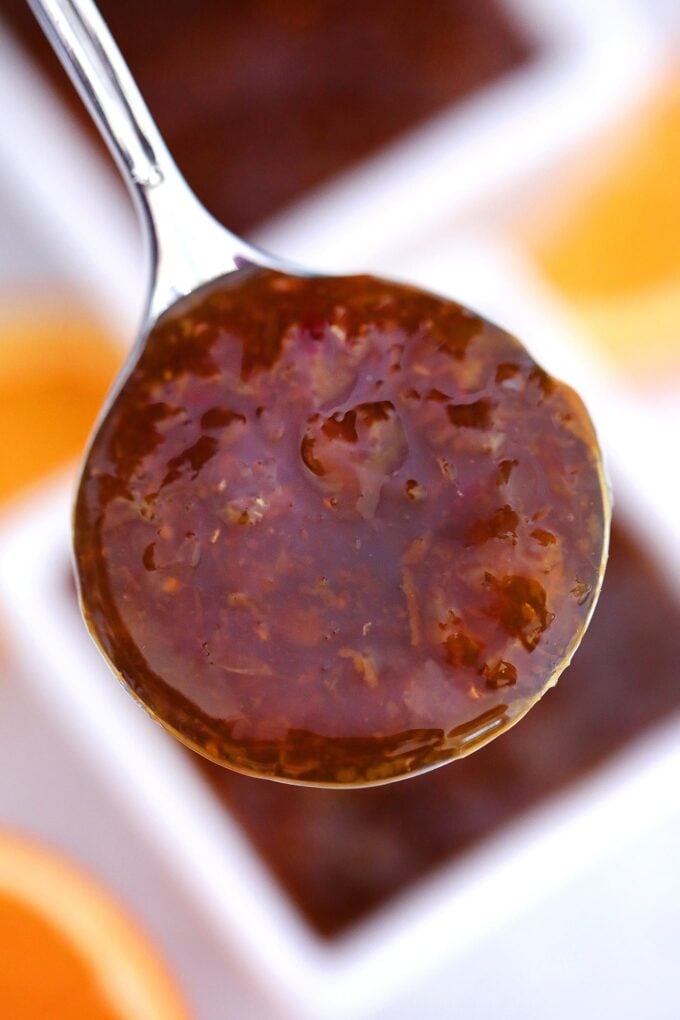 Orange sauce on a silver spoon photo
