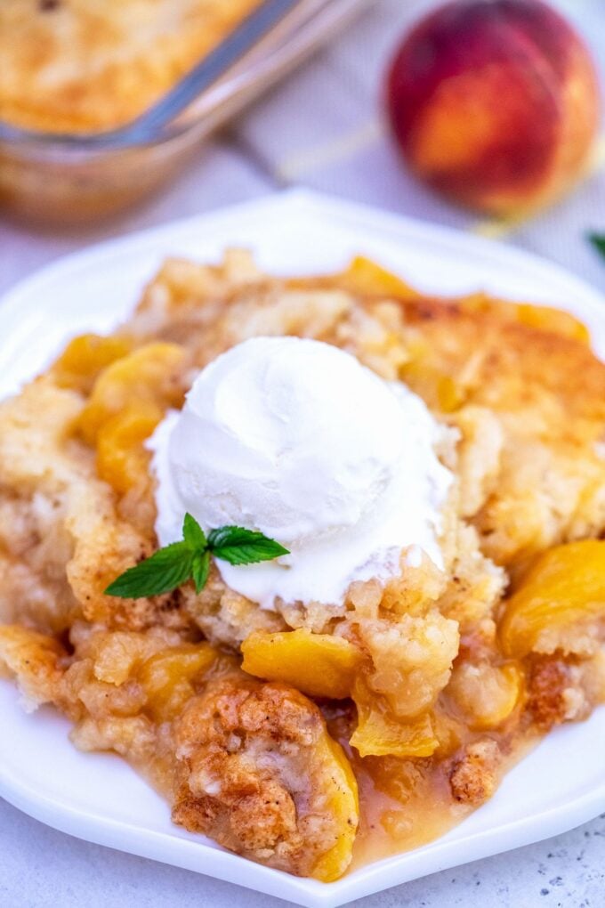 peach cobbler topped with ice cream. 