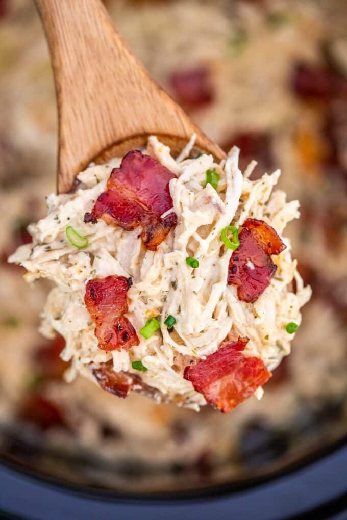 Cooked crack chicken with bacon on a wooden spoon