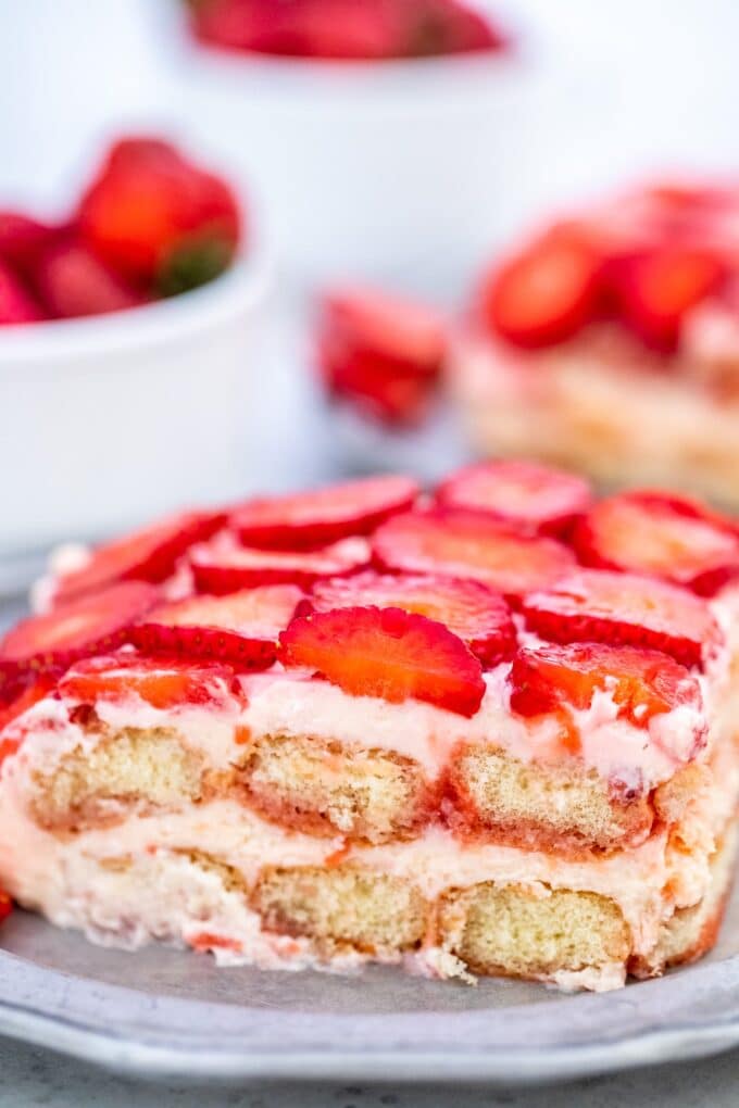 a slice of Strawberry Tiramisu topped with sliced fresh strawberries