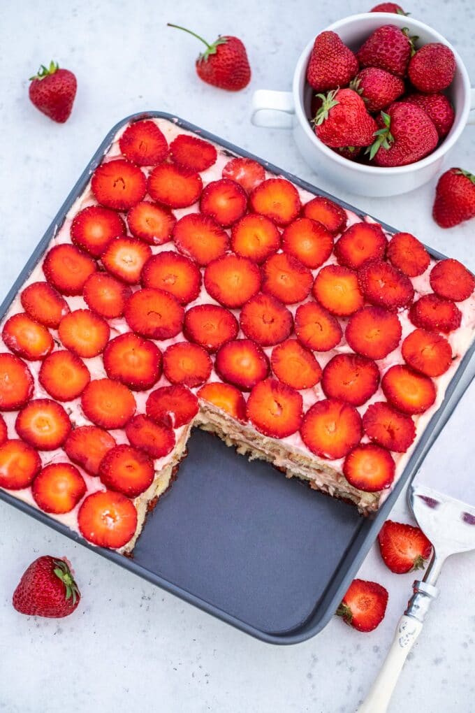 overhead shot of homemade Strawberry Tiramisu in a pan, topped with fresh strawberries