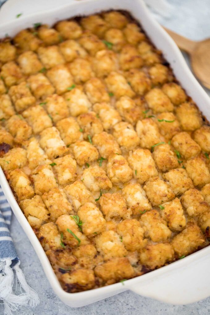 Homemade tater tot casserole in a white baking dish. 