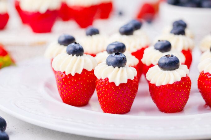 Cheesecake patriotic stuffed strawberries arranged on a serving plate.