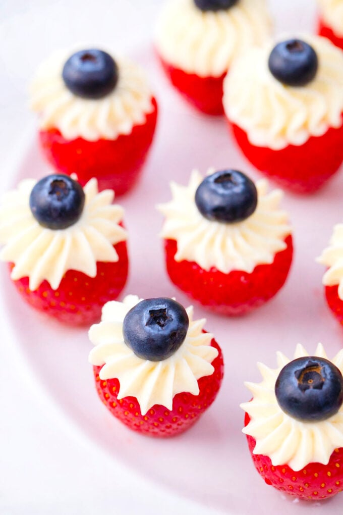 Cheesecake patriotic stuffed strawberries topped with blueberries.
