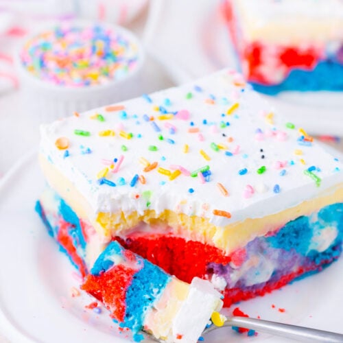 A slice of pink, light blue, and purple unicorn poke cake.