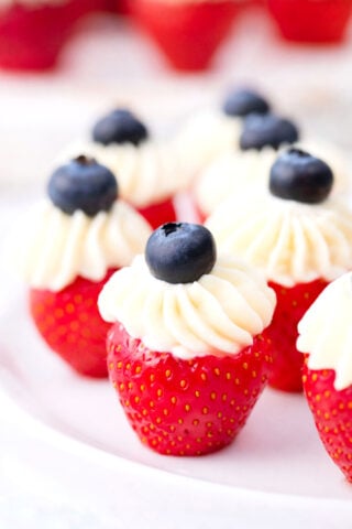 Patriotic stuffed strawberries topped with blueberries.
