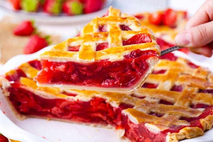 Homemade strawberry pie with lattice top of a serving spatula.