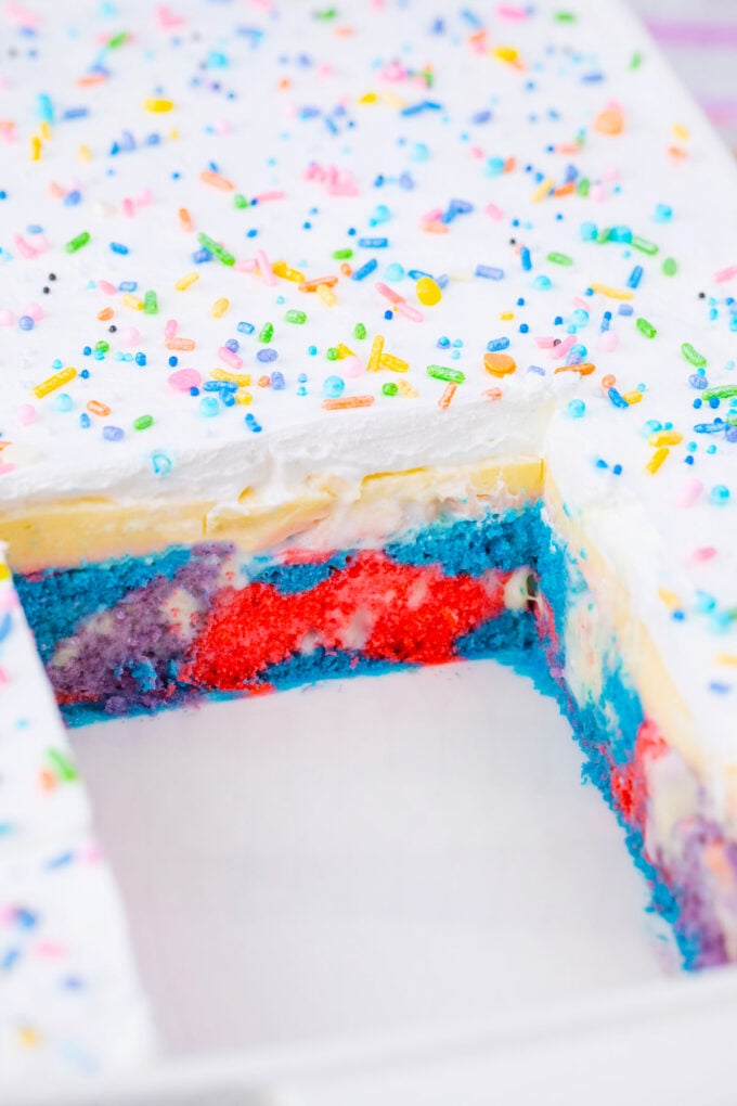 Unicorn poke cake in a baking sheet.