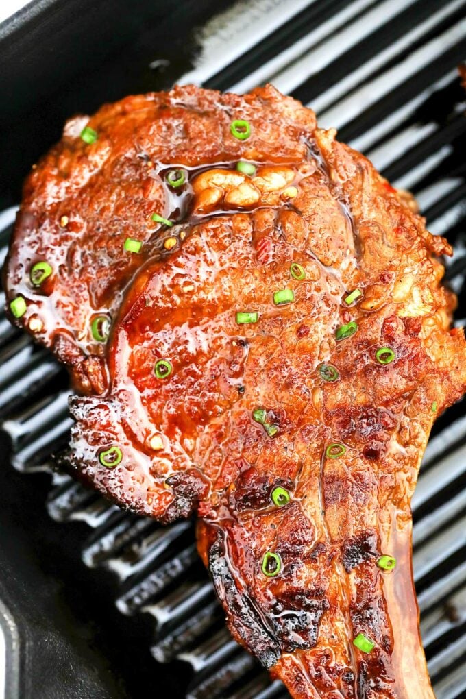 grilled steak with topped with Asian marinade on a grill pan