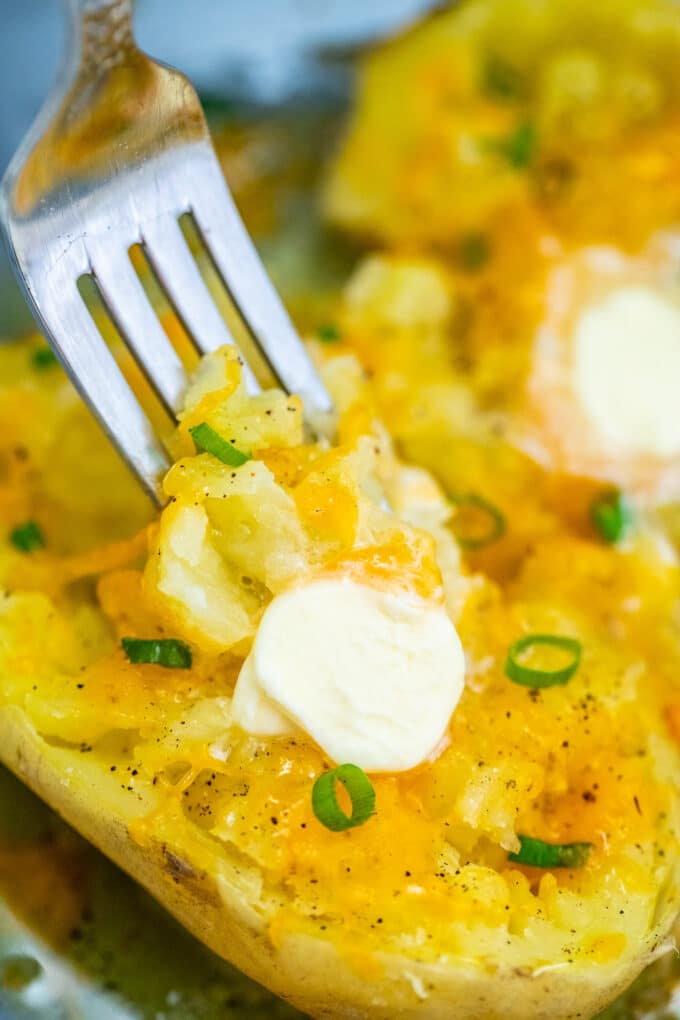 Microwaved potato with butter and cheese photo.