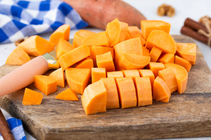 Chopped sweet potatoes on a cutting board.