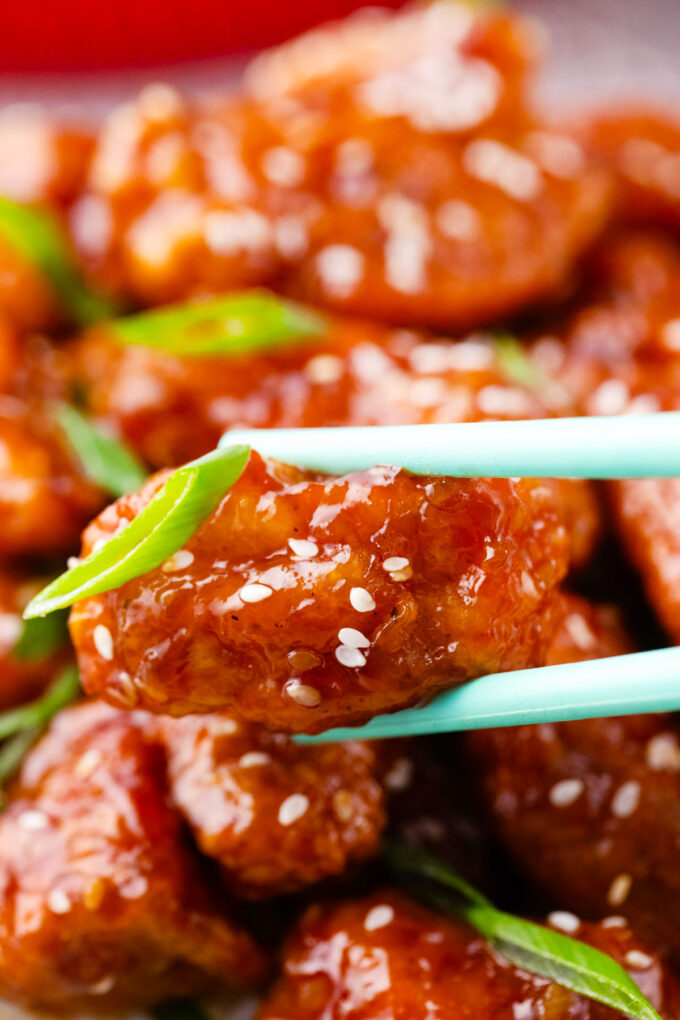 A piece of crispy Asian honey sesame chicken.