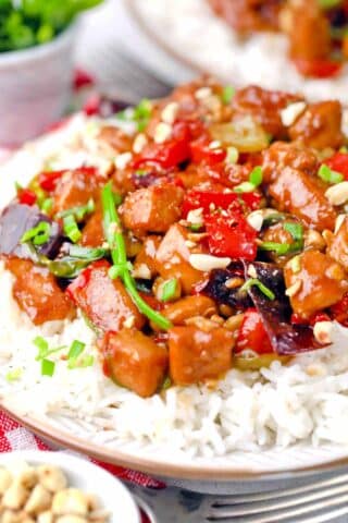 Juicy Kung Pao Chicken and veggies served on top of white rice.