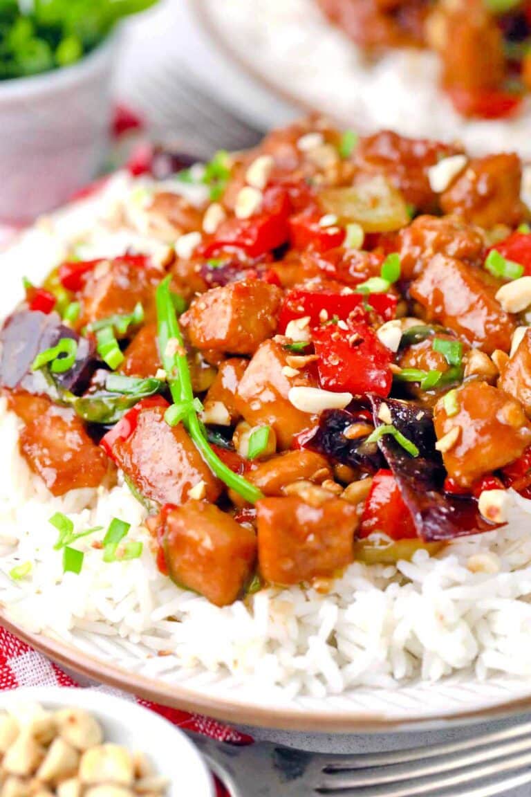 Juicy Kung Pao Chicken and veggies served on top of white rice.