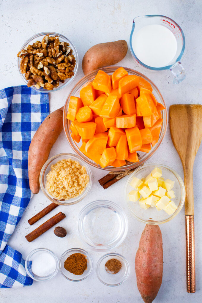 Overhead shot of crockpot mashed sweet potatoes in bowls on a table.