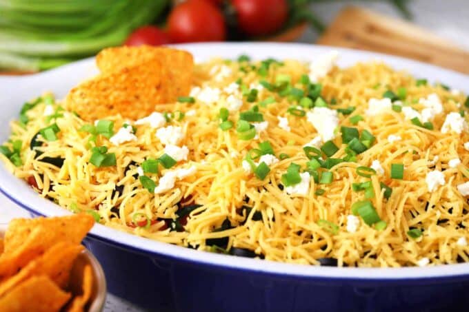 Taco dip topped with grated cheese.