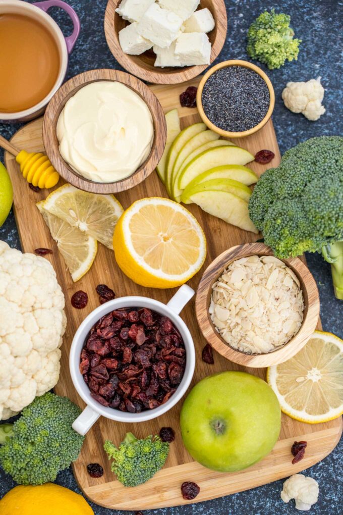 broccoli cauliflower salad ingredients arranged in bowls on a table